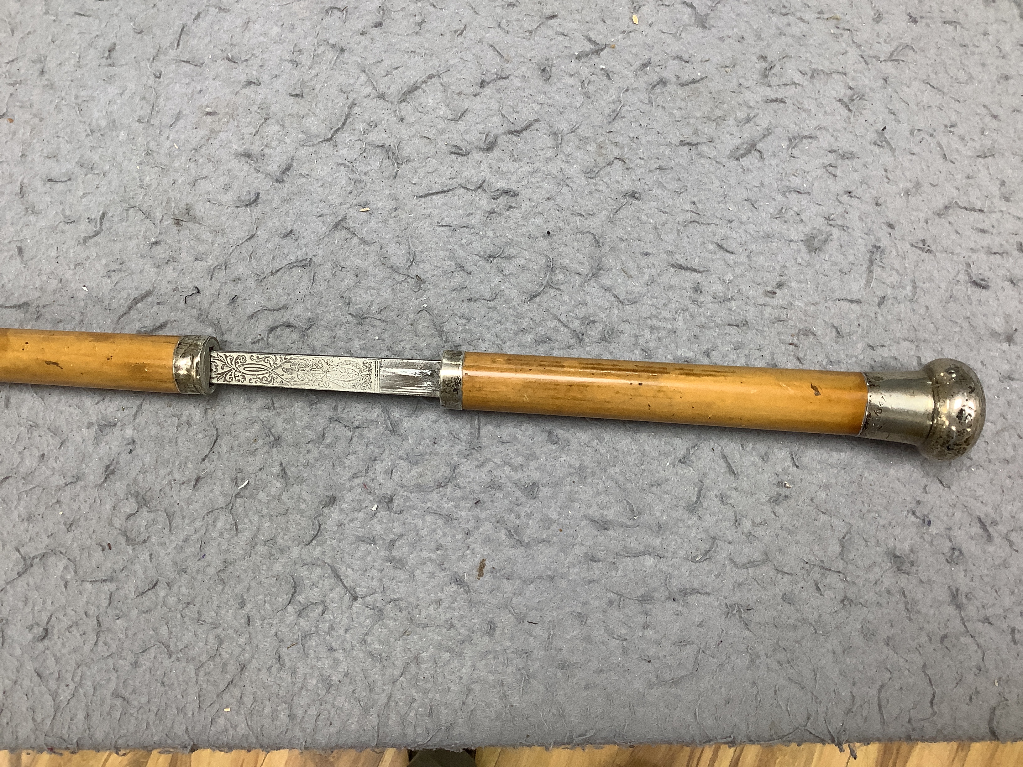 Four Victorian silver mounted handled walking sticks: one being a sword stick, sword stick 90cm long
